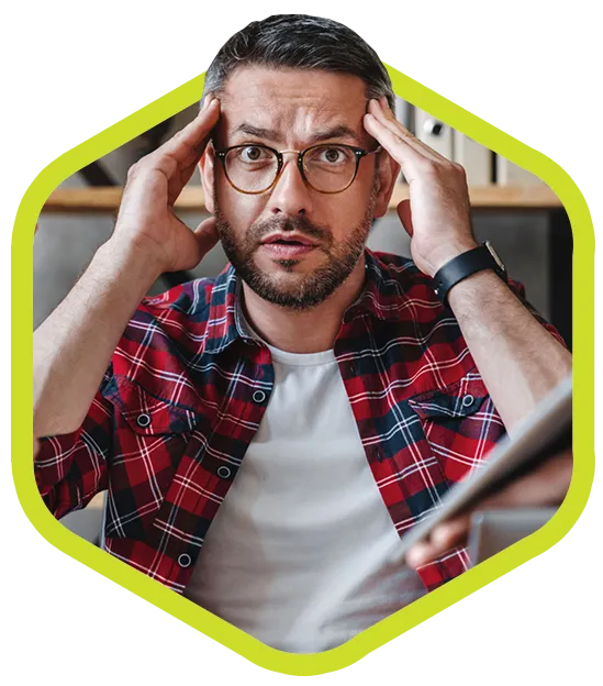Thirty-something white male with glasses rubs temples, looks stressed.